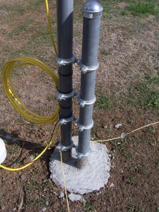 30 Meter MonoGap mounted to vertical post in cement, shows ground radials, and lighting choke
